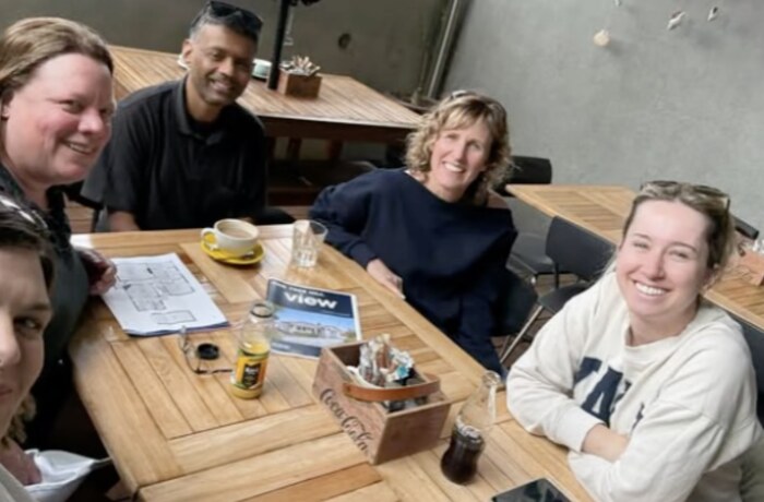 Wealth Mentor members around a table working through a deal